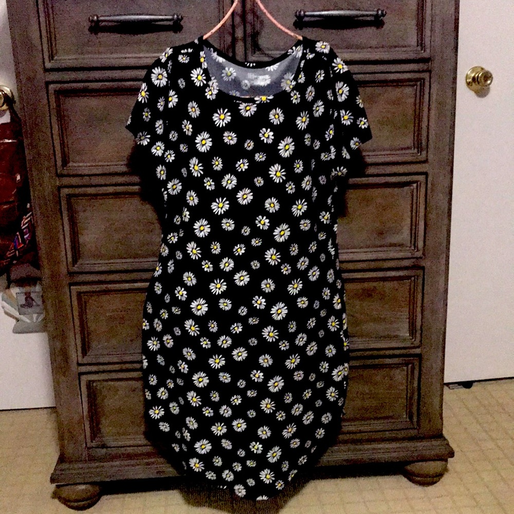 It’s a mini black dress with a little white and yellow flowers
